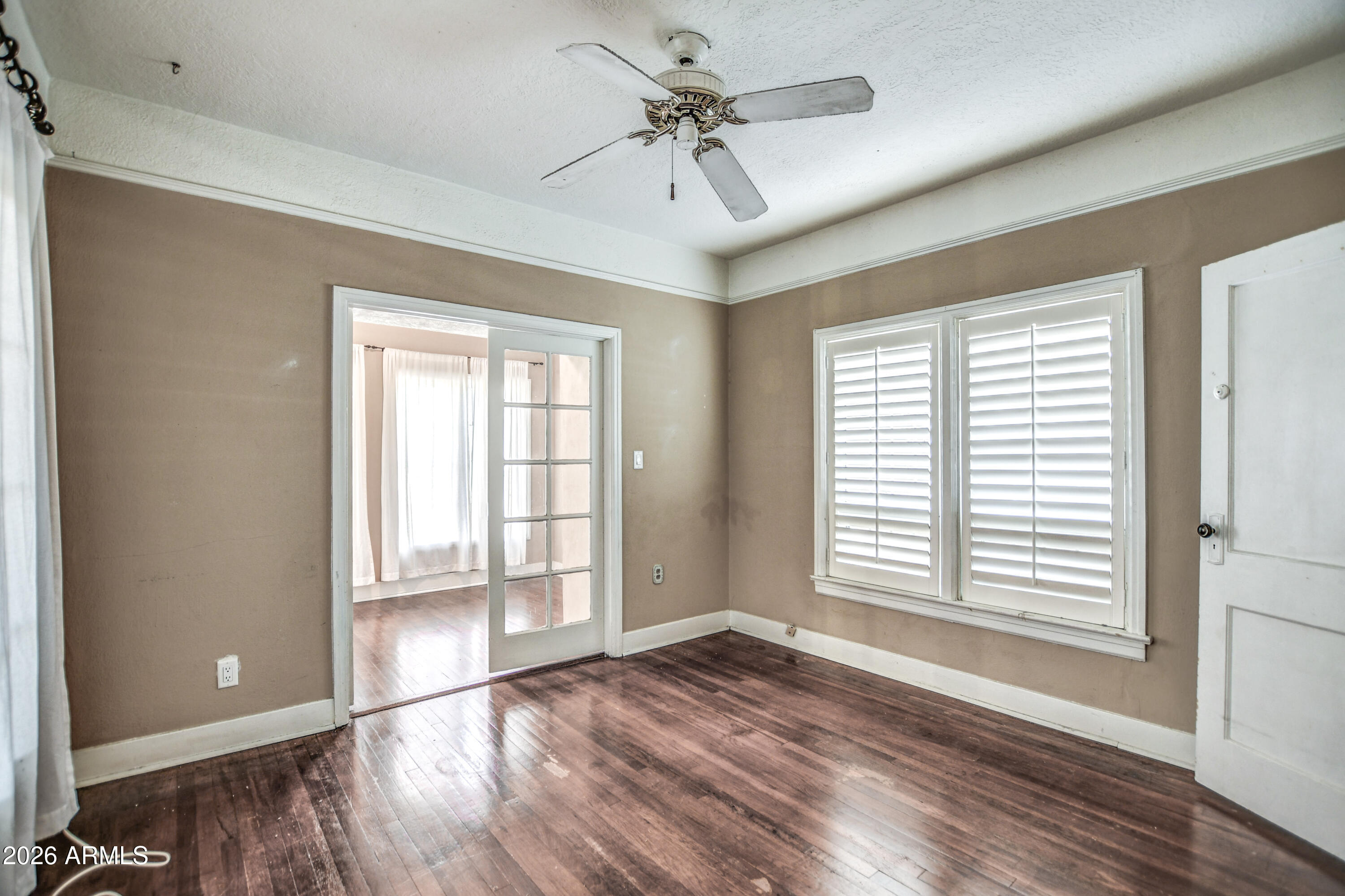 384 East Windsor Avenue Phoenix, AZ 85004 - Photo 32 of 42 a view of an empty room with a window and wooden floor