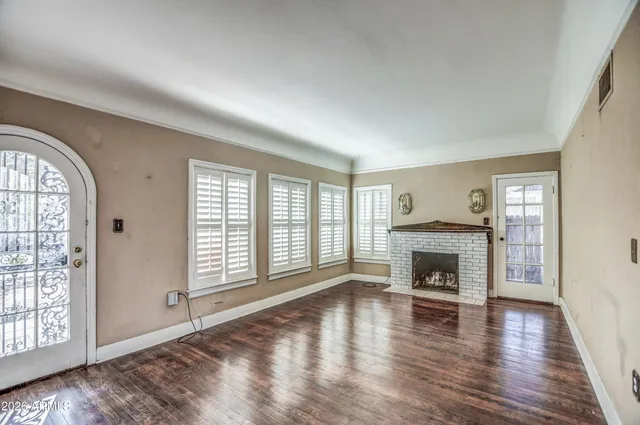 a view of a room with wooden floor and a window