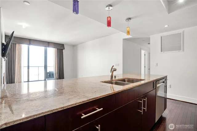 a kitchen with granite countertop a sink and a window