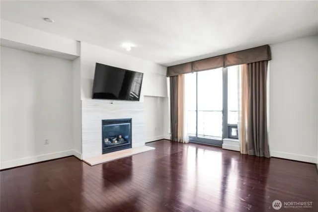 a living room with a fireplace and a flat screen tv