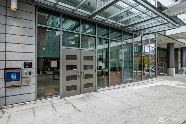 a kitchen with kitchen island granite countertop a sink cabinets and stainless steel appliances