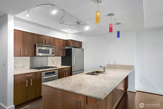 a kitchen with kitchen island a counter top space appliances and cabinets