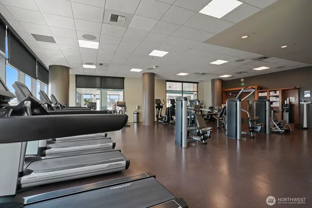 a lobby with furniture and lots of gym equipment
