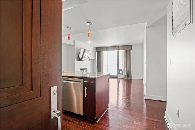 a view of a hallway with wooden floor