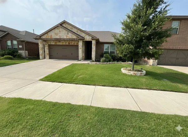 a view of a house with a yard and a garage