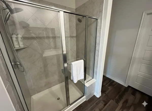 a view of a room with wooden floor and bathroom