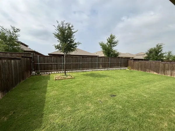 a backyard of a house with lots of green space