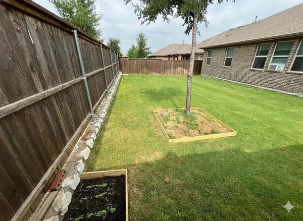 a view of a yard with a fence