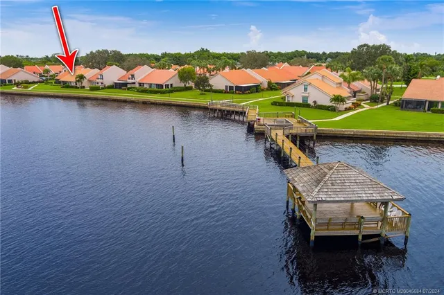 a view of a house with a yard and lake view