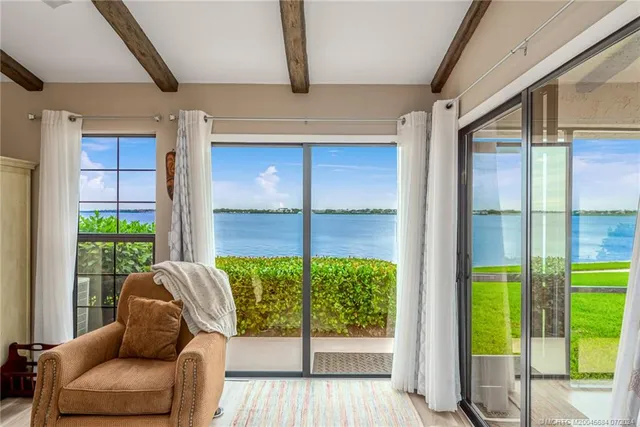a living room with furniture a couch and a ceiling fan