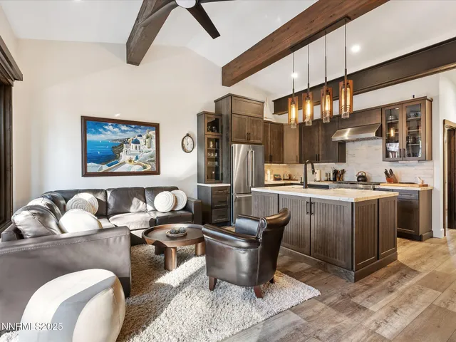 a kitchen with stainless steel appliances granite countertop a stove a sink dishwasher and a refrigerator with wooden cabinets