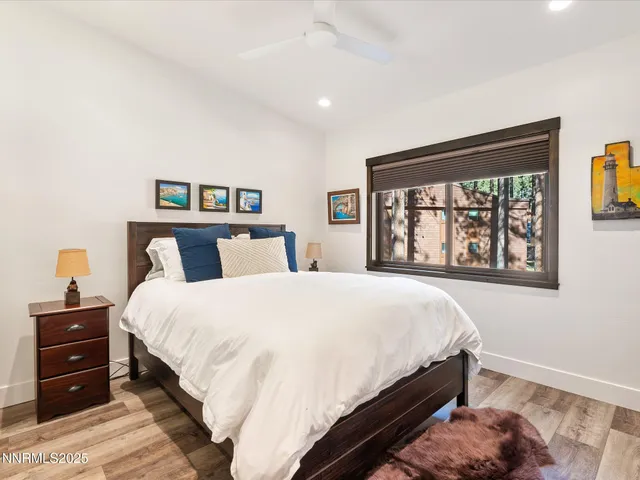 a living room with furniture a flat screen tv and a large window