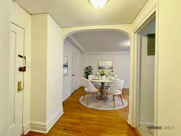 a view of a dining room with a table and chairs