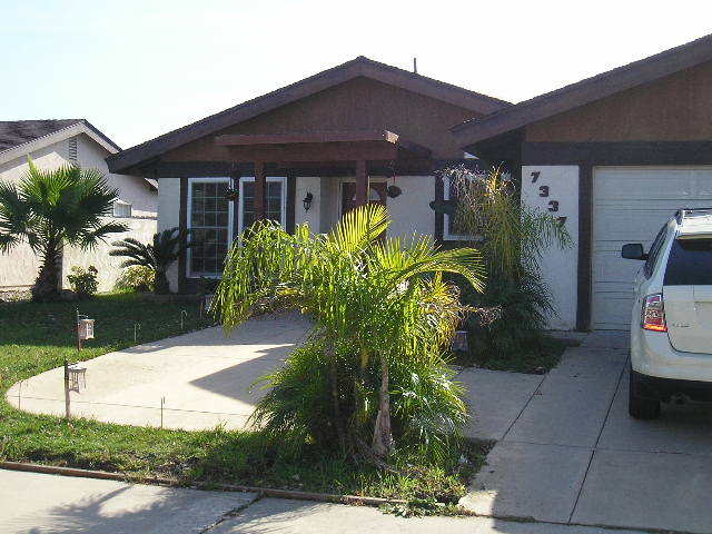a front view of a house with garden
