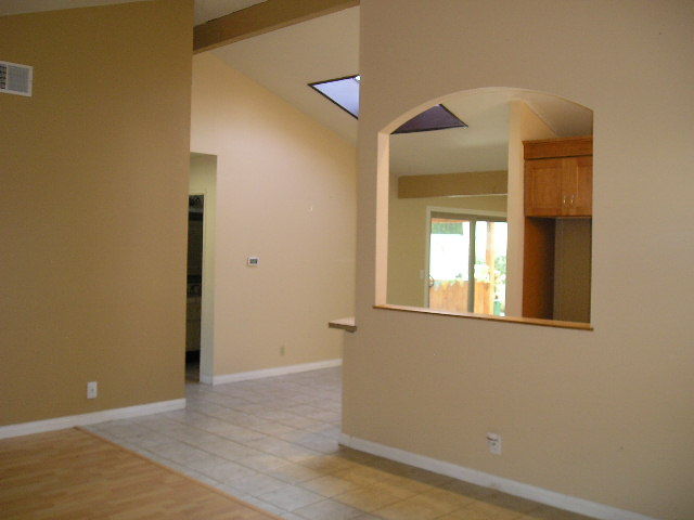 7337 Hillsboro Street Goleta, CA 93117 - Photo 4 of 18 a view of an empty room with wooden floor and a window