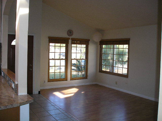 7337 Hillsboro Street Goleta, CA 93117 - Photo 5 of 18 an empty room with wooden floor and windows