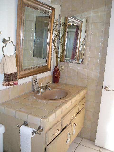 7337 Hillsboro Street Goleta, CA 93117 - Photo 9 of 18 a bathroom with a granite countertop sink and a mirror