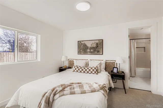 a bedroom with a bed and a painting on the wall