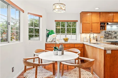 a dining room with furniture a window and a chandelier