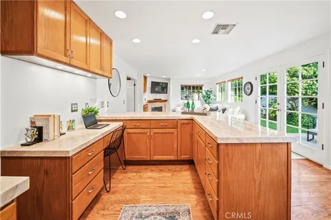 a kitchen with stainless steel appliances granite countertop a sink and a wooden cabinets