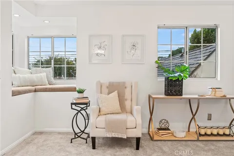 a view of a livingroom with furniture and a potted plant