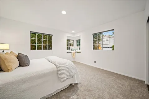 a bedroom with a large bed and a window