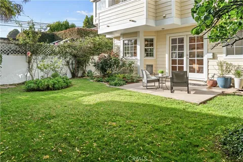 a view of a house with backyard and sitting area