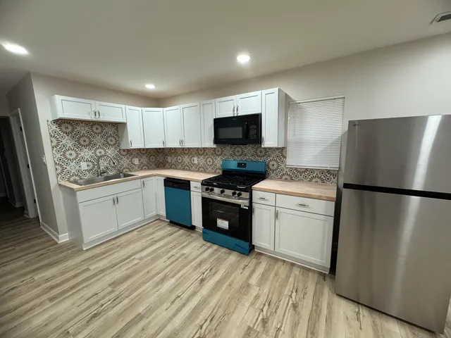 a kitchen with a refrigerator stove and microwave