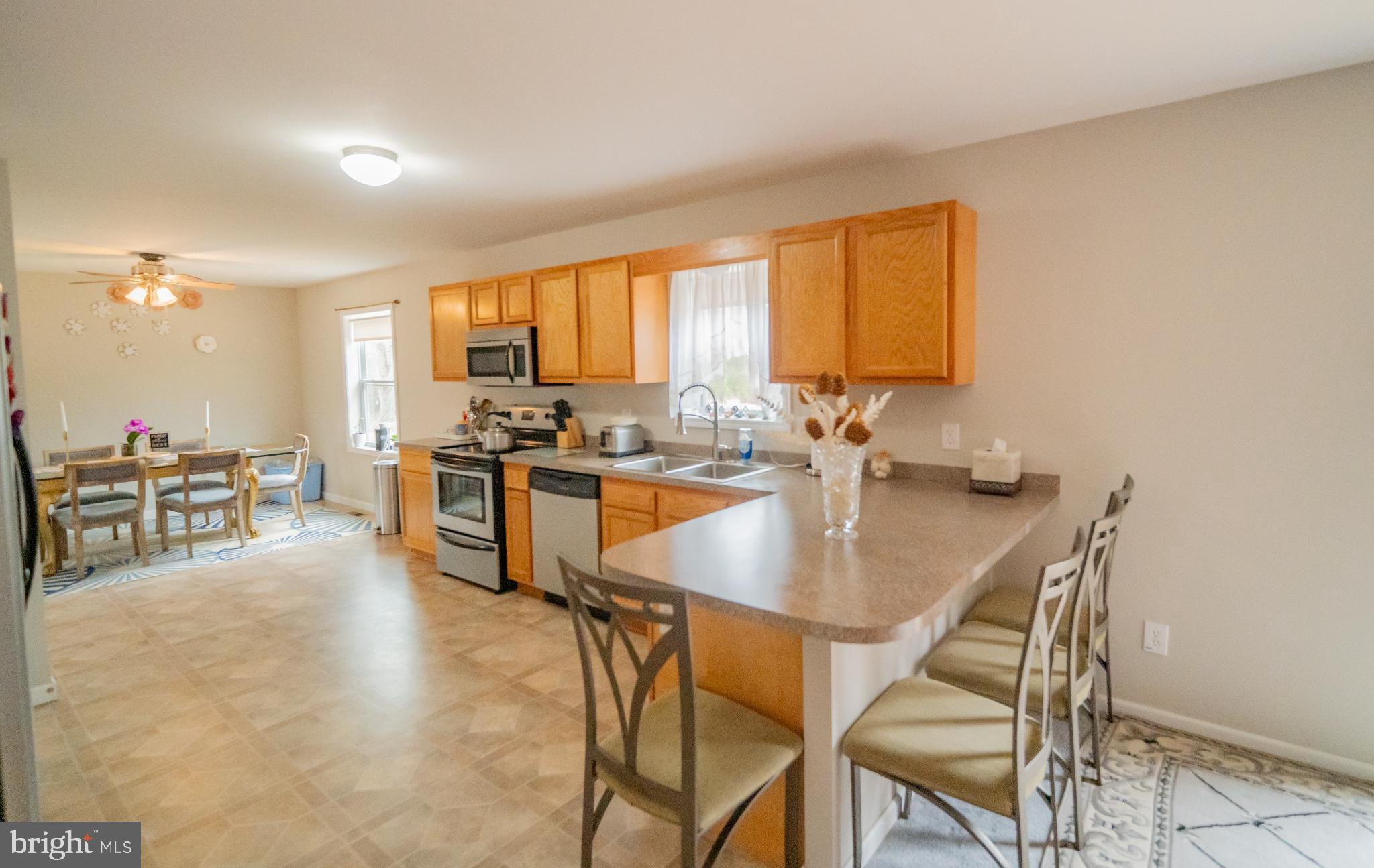 2905 Smith Point Road Nanjemoy, MD 20662 - Photo 7 of 32 a kitchen with a table chairs stove and cabinets