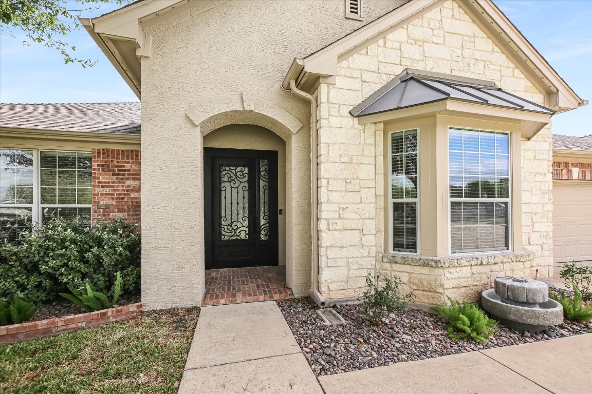 20105 Farm Pond Lane Pflugerville, TX 78660 - Photo 2 of 34 Entrance to property with stone siding and stucco siding