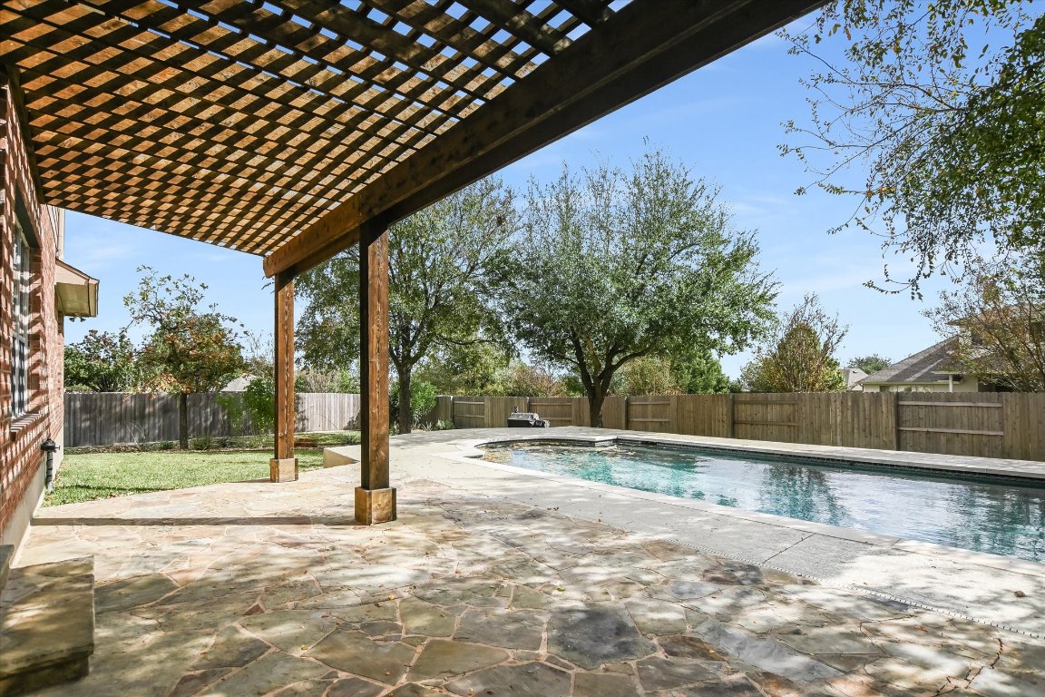 20105 Farm Pond Lane Pflugerville, TX 78660 - Photo 32 of 34 Backyard fun in the pool or relax under the pergola on the patio.