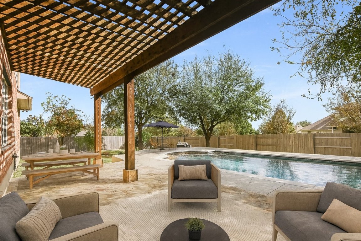 20105 Farm Pond Lane Pflugerville, TX 78660 - Photo 4 of 34 View of swimming pool with a pergola, a patio, a fenced backyard, and an outdoor living space