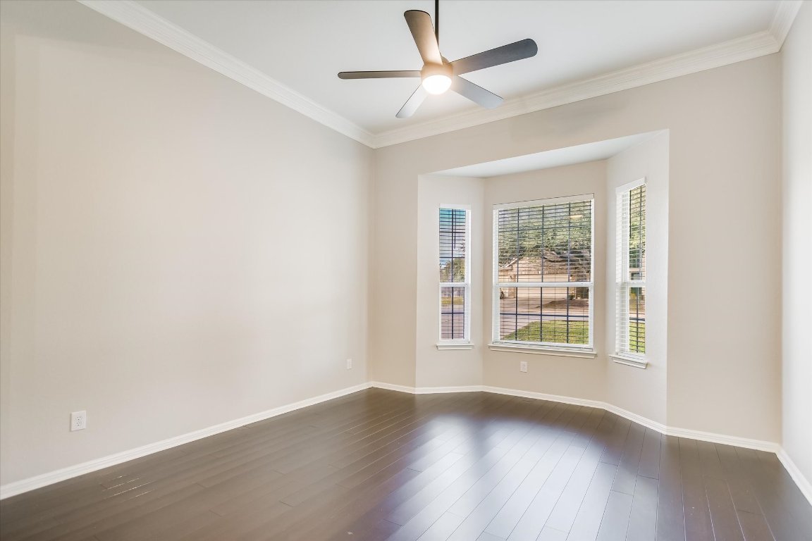20105 Farm Pond Lane Pflugerville, TX 78660 - Photo 8 of 34 Front sitting area featuring crown molding and dark wood-style floors.