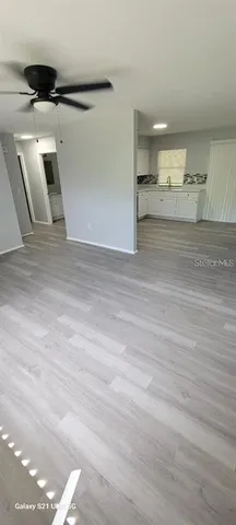 a view of a room with wooden floor