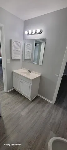 a room with a mirror and vanity