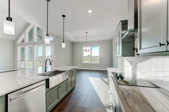 a view of an empty room with a fireplace and a window