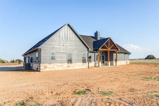a view of a house with snow on the road
