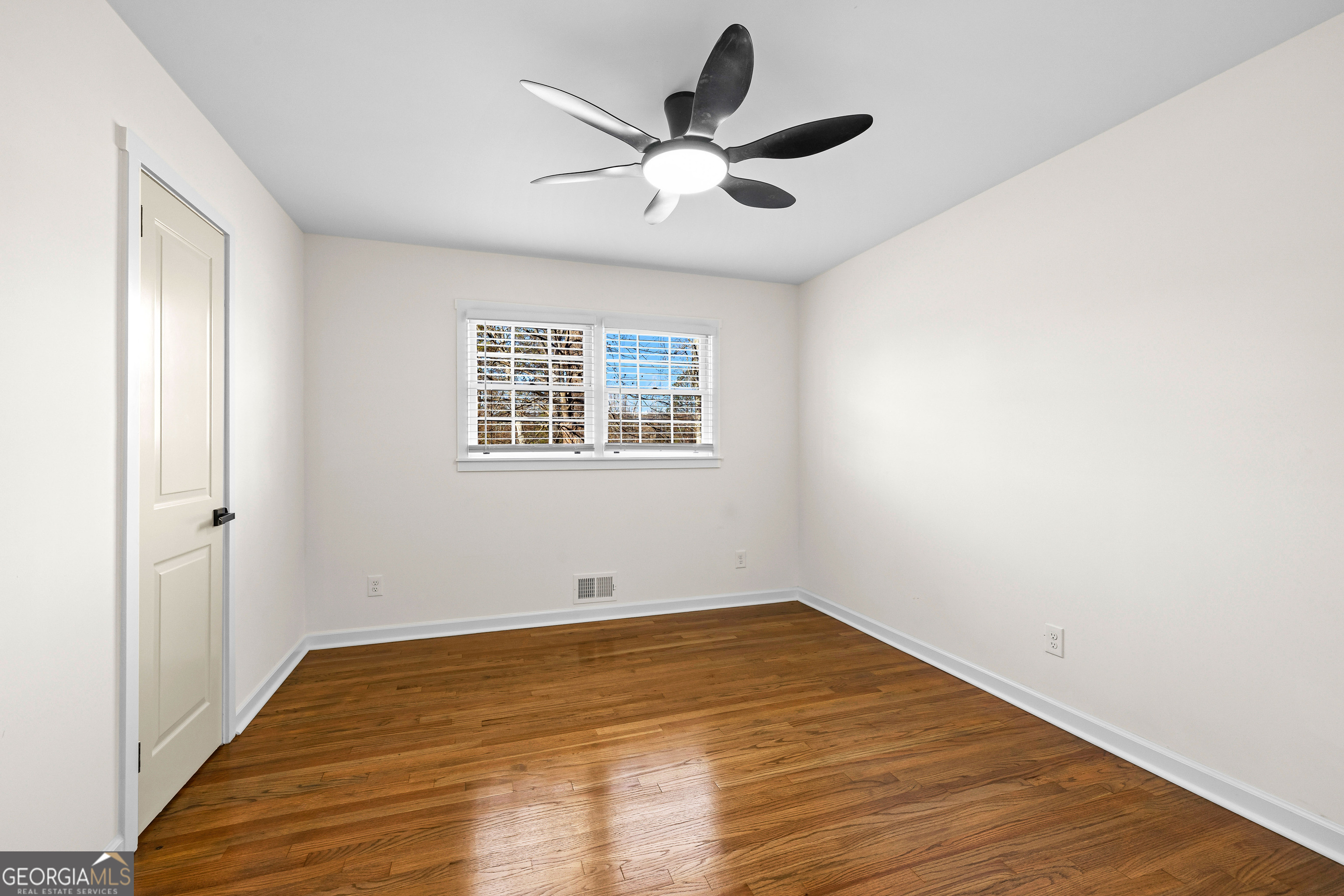 201 Smithstone Path Fayetteville, GA 30214 - Photo 22 of 57 a view of a room with wooden floor and a ceiling fan