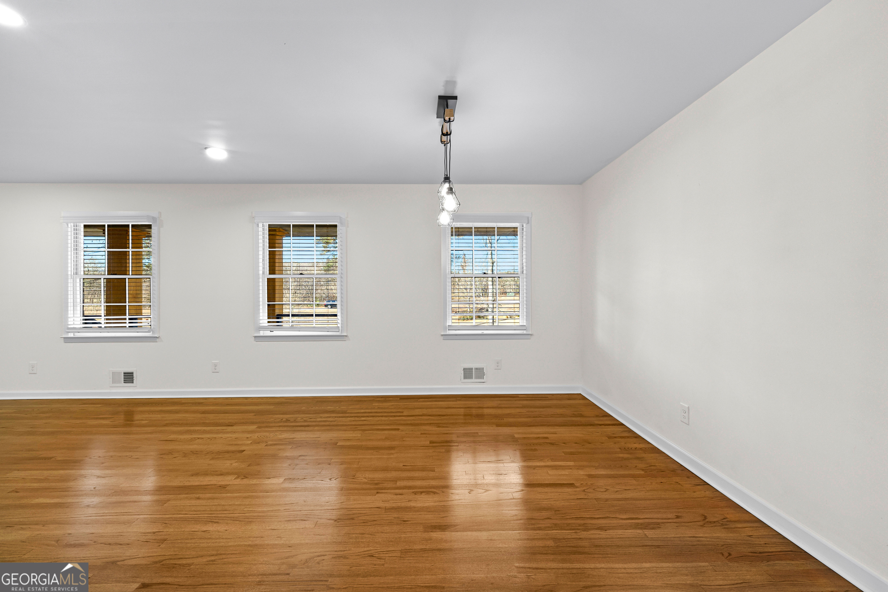 201 Smithstone Path Fayetteville, GA 30214 - Photo 10 of 57 a view of an empty room with window and wooden floor