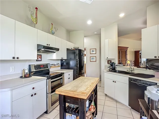 a kitchen with stainless steel appliances a stove refrigerator sink and cabinets