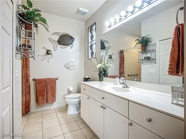 a spacious bathroom with a toilet sink and mirror