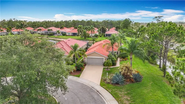 an aerial view of residential houses with outdoor space and trees