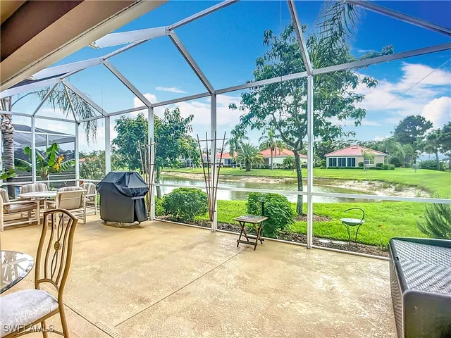 a view of a patio with table and chairs under an umbrella