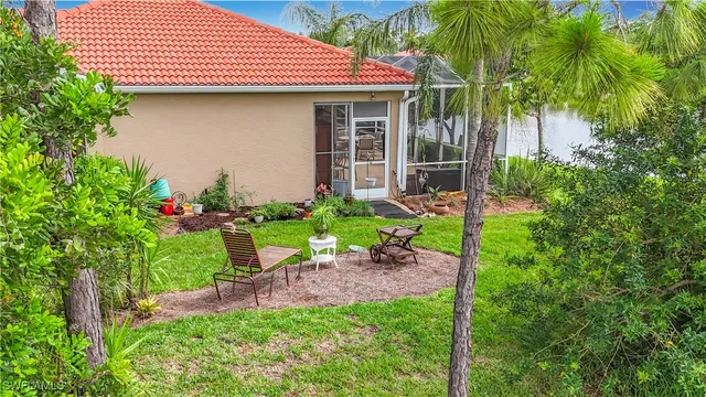 a front view of a house with a yard and potted plants