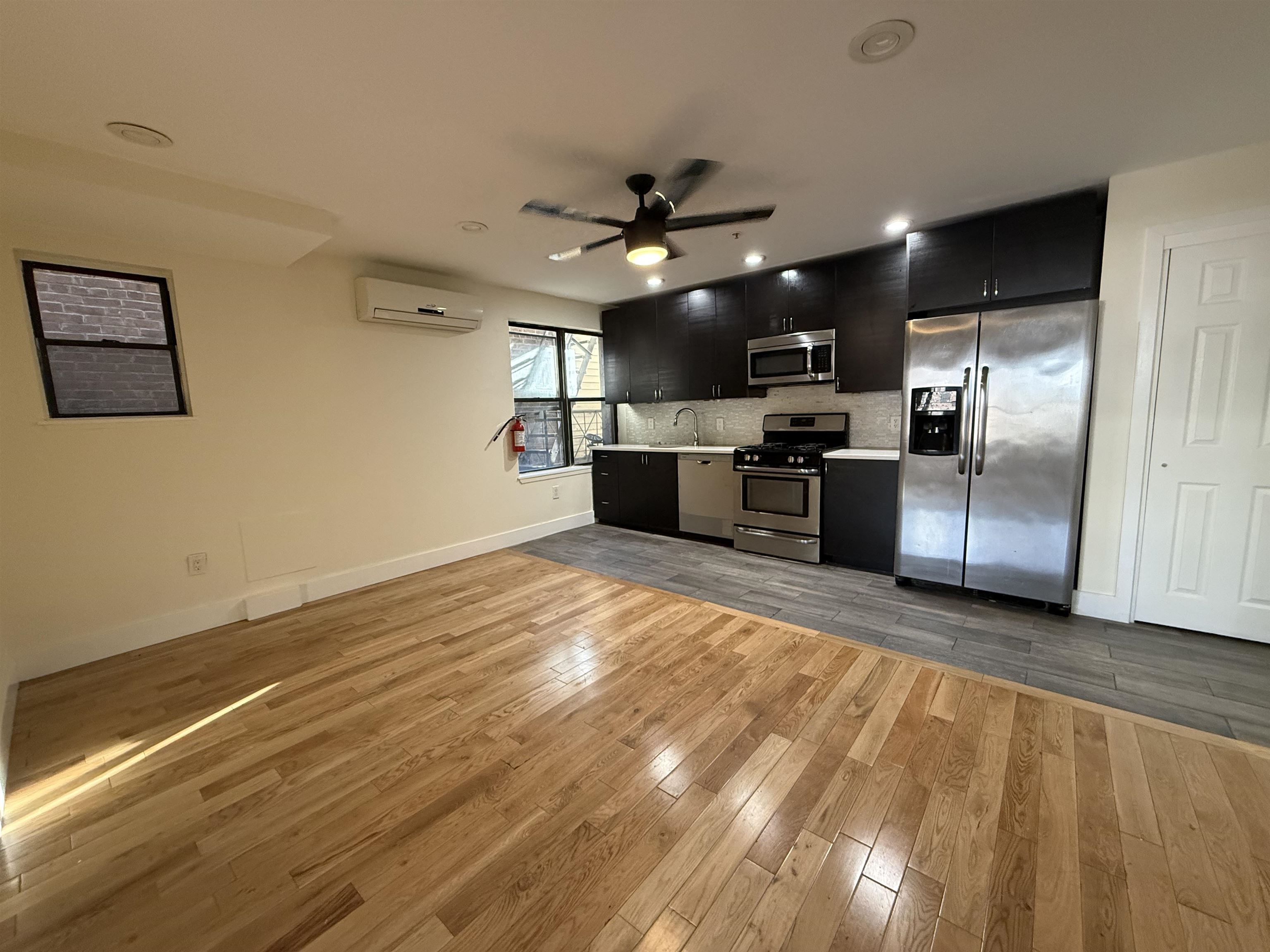 73-75 Ferry Street, Unit 7 Newark, NJ 07105 - Photo 4 of 11 a view of a kitchen with a sink wooden cabinets and stainless steel appliances