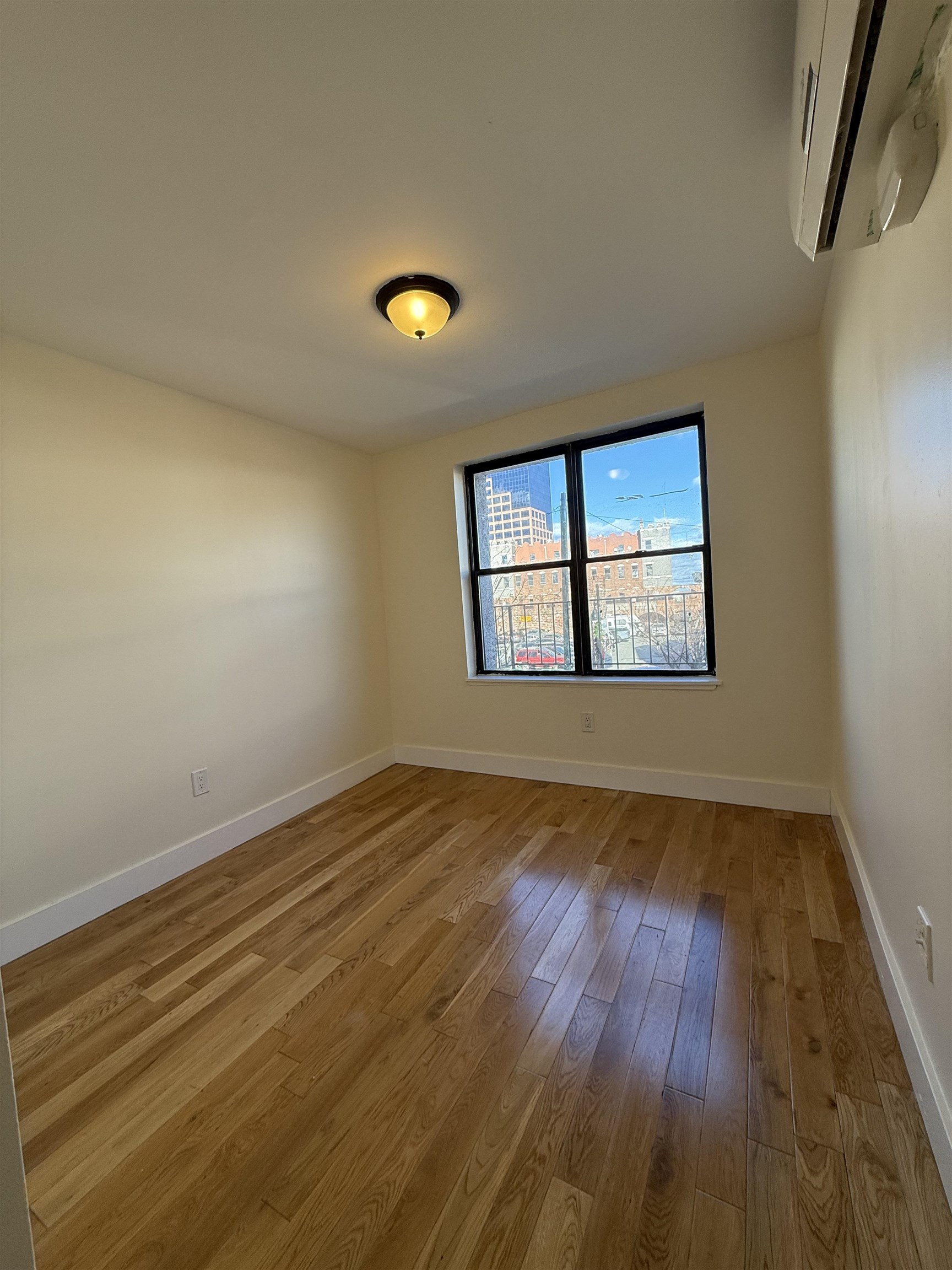 73-75 Ferry Street, Unit 7 Newark, NJ 07105 - Photo 5 of 11 an empty room with wooden floor and windows