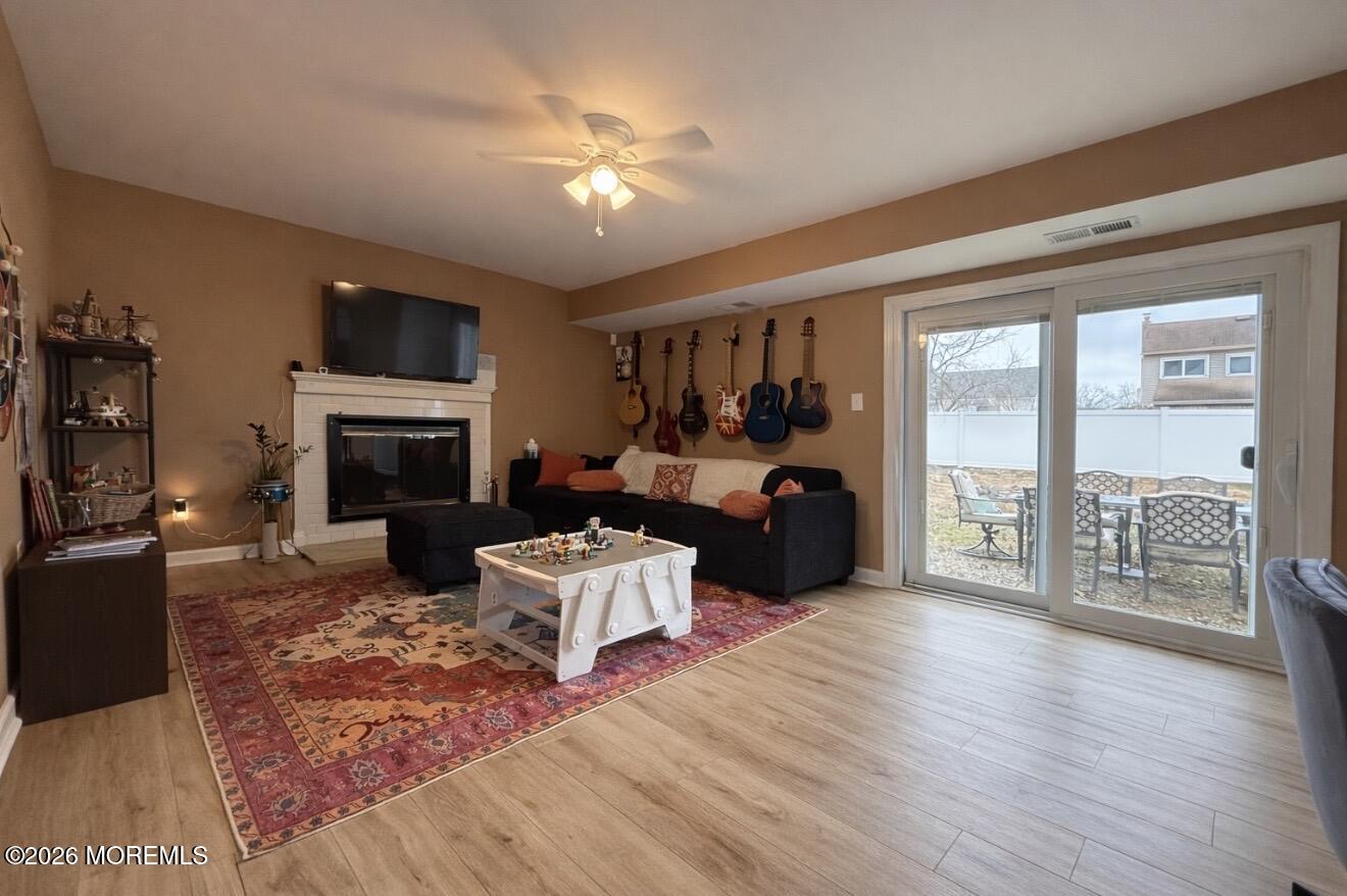 15 Commodore Court Barnegat, NJ 08005 - Photo 12 of 19 a living room with furniture a fireplace and a flat screen tv