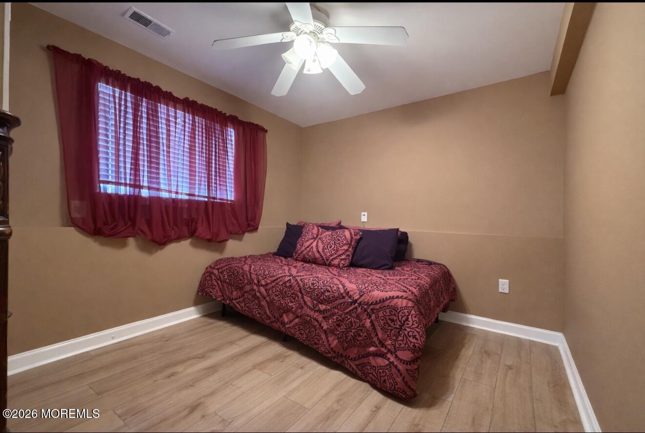 15 Commodore Court Barnegat, NJ 08005 - Photo 15 of 19 a bedroom with a bed and a chandelier