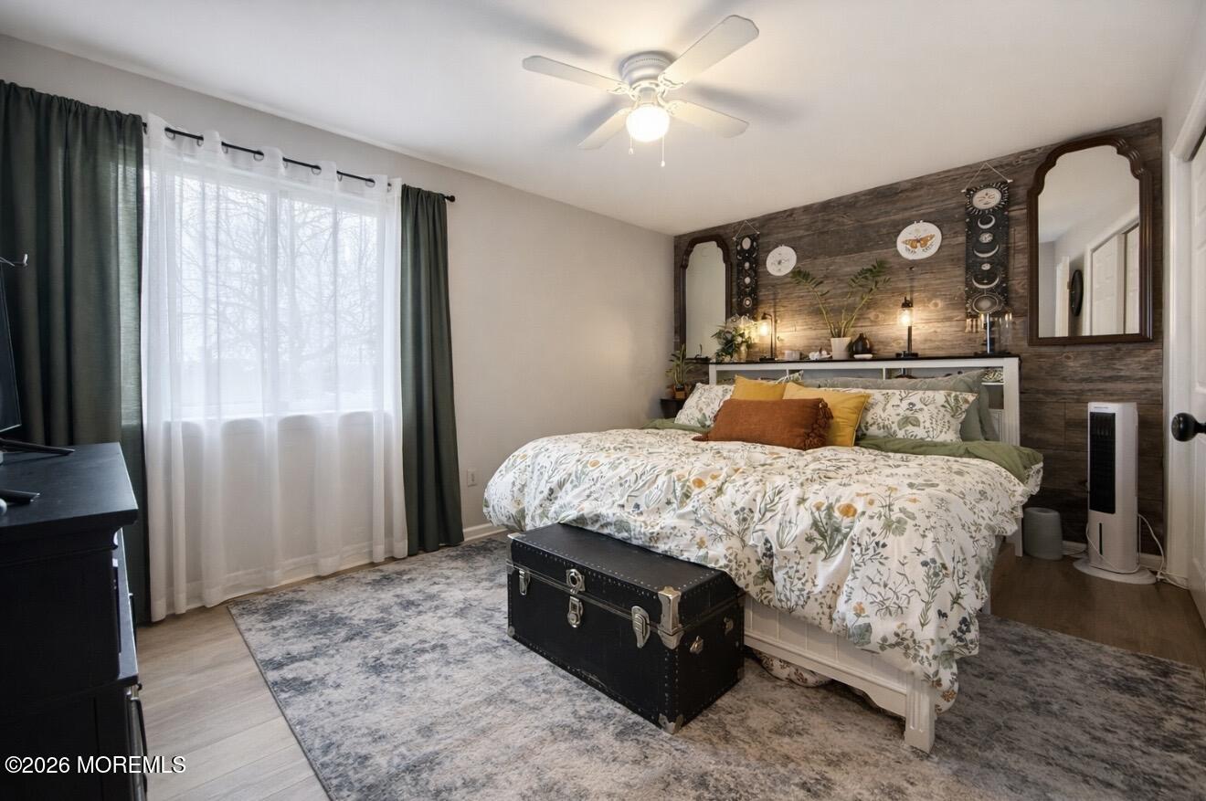 15 Commodore Court Barnegat, NJ 08005 - Photo 8 of 19 a bedroom with a large bed and a chandelier