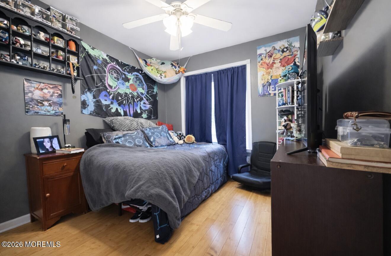 15 Commodore Court Barnegat, NJ 08005 - Photo 9 of 19 a bedroom with a bed and a chandelier